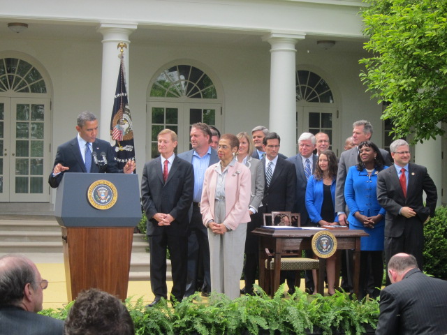 President Barack Obama speaking at the White House Rose Garden ceremony, with attendees standing behind him