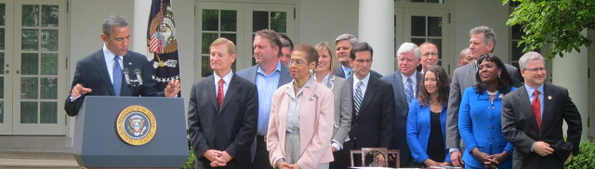 President Barack Obama speaking at the White House Rose Garden ceremony, with attendees standing behind him