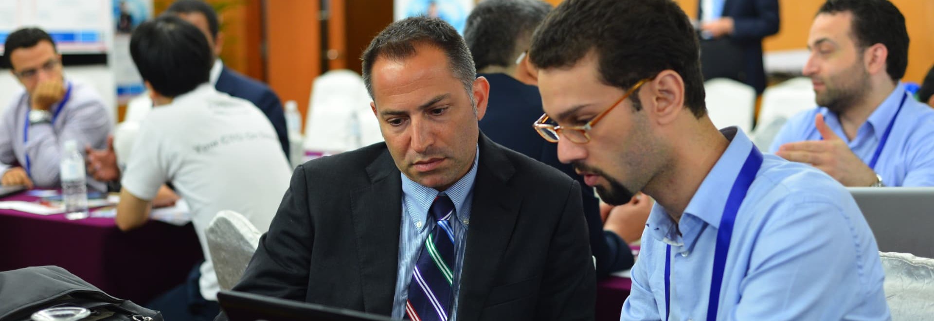 Advisers reviewing an offering together on a laptop at a crowdfunding workshop